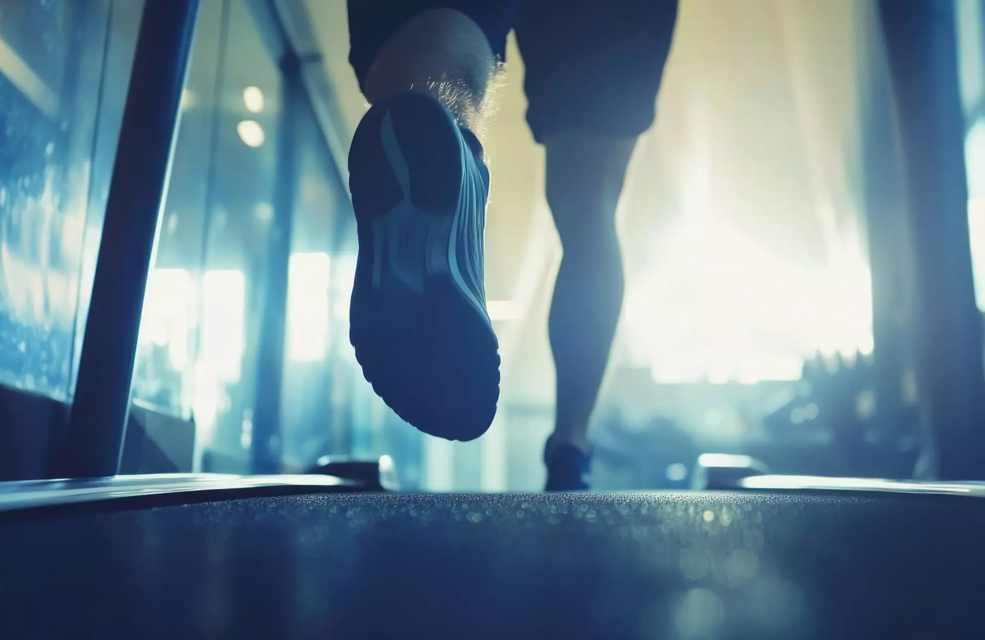 Sanitätskaufhaus Kellner - Relaunch 2025 - Stockmaterial Rehabilitationstechnik - Mann läuft in Sportschuhen über den Asphalt im Morgenlicht